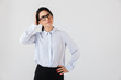 © Drobot Dean - Image of caucasian businesswoman wearing eyeglasses standing in the office, isolated over white background