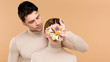 © LIGHTFIELD STUDIOS - tender man with alstroemeria flowers on hand covering face of girlfriend isolated on beige