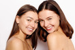 © Misha - make up and skin care concept - Portrait of a two beautiful sexy young women - Isolated on white. Two smiling attractive girl friends
