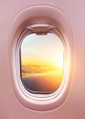 Wall Mural - airplane interior with window view of sunset above clouds.
