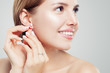 © artmim - Beautiful bride in puts on diamond earring. Beauty model girl in wedding jewelry, perfect face closeup
