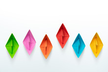 Multicolored Paper Boats On A White Background, Business Competition Concept With Copy Space