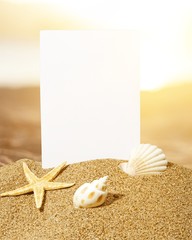 Sticker - Seashells and starfish with blank card on sand beach