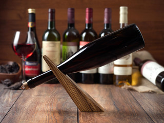 A bottle of red wine on a modern wooden stand