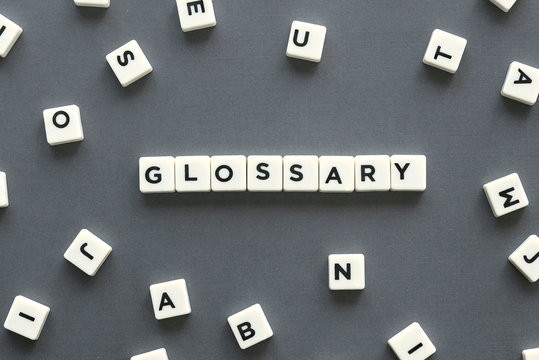 Glossary word made of square letter word on grey background.
