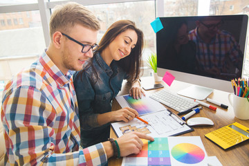 Cute creative designers working on new project in modern office