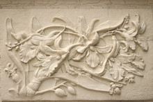 Beautiful White Java Stucco Patterned On The Boundary Wall. Vintage White Wall Bas-relief Stucco In Plaster, Depicts Lotus Flowers Background.