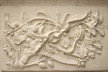 Beautiful white Java stucco patterned on the boundary wall. Vintage white wall bas-relief stucco in plaster, depicts Lotus flowers background.