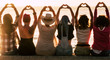 © simona - Love and meditation lifestyle concept - group of women looking at the sunset on the ocean and make the hearth with hands - romantic golden light and valentine's day concept - friendshp forever