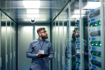 Wall Mural - IT engineer with tablet in server room