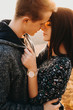© Strelciuc - Portrait of a amazing couple embracing and face to face close with closed eyes wanting to kiss smiling against sunset in their vacation time.
