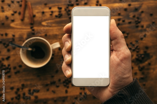 Plakat Smartphone in hand mock up and coffee cup top view