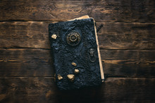 Ancient Magic Book On A Wooden Table Background. Spellbook.