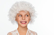 Portrait of a cheerful, energetic eight-year-old girl in a white wig and with white freckles