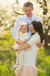 © Anton - Caring family in the flowering park. Springtime and summer mood