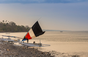 Wall Mural - Traditional sailing boat at sunset on Bali, Indonesia