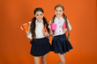 © be free - Schoolgirl hold book or notepad and mug. School routine. Having break relax. Drinking tea while break. School mates relaxing with drink. Enjoy being pupil. Girls kids school uniform orange background