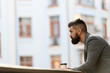 Businessman well groomed appearance enjoy coffee break out of business center urban background. Relax and recharge. Man bearded hipster drink coffee paper cup. One more sip of coffee. City lifestyle