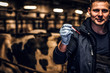 © Fxquadro - A veterinarian holding a test-tube with red liquid on a cow farm indoors
