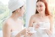 two women friend talking together in spa relax drink tea or coffee.
