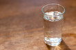 drinking water in the glass on wooden table with copy space.