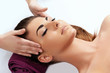 © verona_studio - Face massage. Close-up of young woman getting spa massage treatment at beauty spa salon.Spa skin and body care of female. Facial beauty treatment.Cosmetology