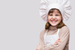 © Svetlana - Children cook. Happy little girl in chef uniform holds rolling pin isolated on white background.