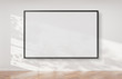 © sdecoret - Black frame hanging on a wall mockup 3d rendering