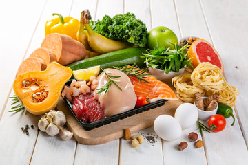 Balanced diet concept - fresh meat, fish, pasta, fruits and vegetables, nuts, seeds copy space