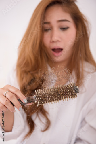 Portrait Of Asian Woman Long Hair With A Comb And Problem Hair On