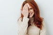 © contrastwerkstatt - Smiling attractive woman covering one eye