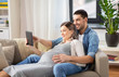 © Syda Productions - pregnancy, technology and people concept - happy man and his pregnant wife with tablet pc computer at home