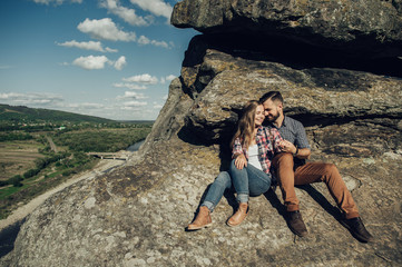 Hipster couple in love having fun together posing in mountain.