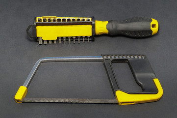 A set of tools on a gray background pliers, screwdriver.