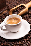 Fototapeta Boho - Coffee cup over dark roasted coffee beans