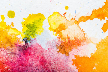 Wall Mural - top view of yellow, orange and pink watercolor spills on white paper