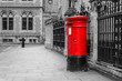 © shootingtheworld - The traditional British red post box in London standing on the street. Isolated in a black and white picture.