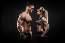 Sporty Young Couple Posing On Black Background