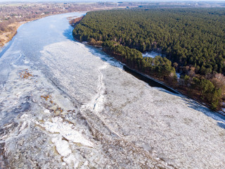 Aerial view of frozen river. Aerial view of ice. Aerial shot of river in winter.