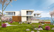 © korisbo - 3d rendering of modern cozy house by the river with garage. Fresh spring day with a blooming garden. For sale or rent with flowers of sakura on background