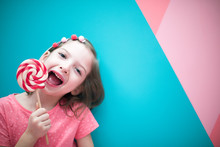 Girl With A Lollipop. On A Bright Background-Image