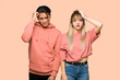 © luismolinero - Young couple with an expression of frustration and not understanding over pink background