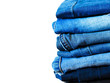 © Anastasia Sokolova - Blue jeans isolated on white background. Jeans stacked on a light background. Jeans background. Stack of clothing  close up, top view. Beauty and fashion,wardrobe and clothing concept.Online shopping