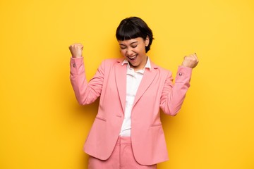 Wall Mural - Modern woman with pink business suit celebrating a victory
