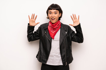 Woman with leather jacket and handkerchief with surprise and shocked facial expression