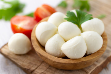 Wall Mural - Mozzarella cheese in wooden bowl. Rustic style.