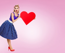Smiling Woman Holding Heart Symbol, Dressed In Pin-up Style