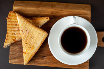 two sandwiches and coffee on a stone background