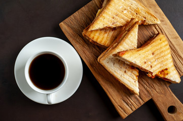 two sandwiches and coffee on a stone background