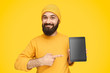 © kegfire - Smiling bearded guy showing modern tablet